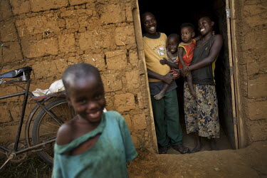 A familiy stand outside of their house during the Mother and Child Health Week held in April 2010. This includes a mass drug administration against intestinal worms and schistosomiasis. Around 14 mill...