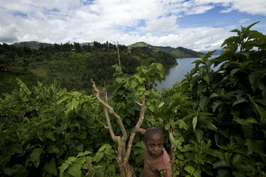 A small child climbs a tree during the Mother and Child Health Week held in April 2010. This includes a mass drug administration against intestinal worms and schistosomiasis. Around 14 million 16 year...