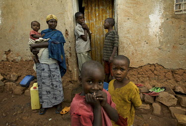 Women and children outside of their home in Kigali, Rwanda, during the Mother and Child Health Week held in April 2010. This includes a mass drug administration against intestinal worms and schistosom...
