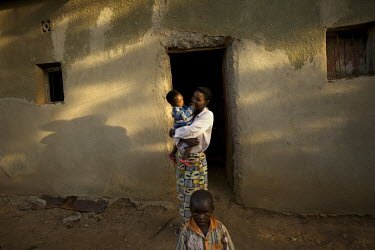 A woman holds her child in the Kibenga Community, Rwanda, during the Mother and Child Health Week held in April 2010. This includes a mass drug administration against intestinal worms and schistosomia...