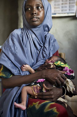 A mother holds her malnourished child in the supplementary feeding ward at a hospital run by IRC (the International Rescue Committee) at Dadaab refugee camp. Since Al Shabaab, an Islamic militia with...