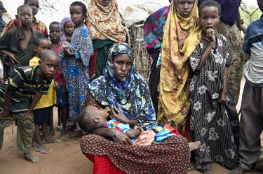 A mother breastfeeds her baby at Dadaab refugee camp. Since Al Shabaab, an Islamic militia with alleged links to Al Qaida, is controlling large parts of Somalia and imposing tough Sharia laws, many ci...