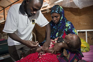 A doctor gives an injection to a malnourished baby in an intensive care ward at a hospital run by IRC (the International Rescue Committee) supported by Stichting Vuchteling NGO at Dadaab refugee camp....