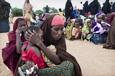 Women and children line up at Dadaab refugee camp. Since Al Shabaab, an Islamic militia with alleged links to Al Qaida, is controlling large parts of Somalia and imposing tough Sharia laws, many civil...