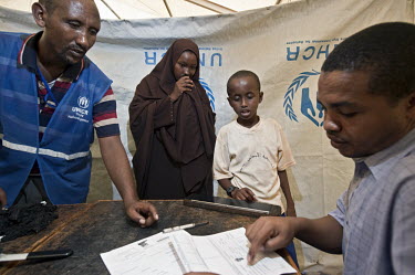 A mother and her children are registered by UNHCR (United Nations High Commissioner for Refugees) at Dadaab refugee camp. Since Al Shabaab, an Islamic militia with alleged links to Al Qaida, is contro...