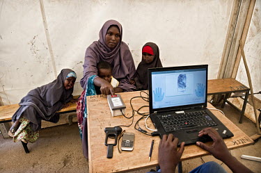A mother registers by giving her thumbprint at Dadaab refugee camp. Since Al Shabaab, an Islamic militia with alleged links to Al Qaida, is controlling large parts of Somalia and imposing tough Sharia...