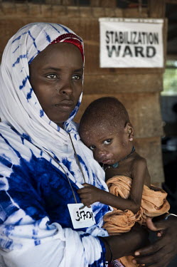 A woman holds her malnourished baby in the stabilisation ward at a hospital at Dadaab refugee camp. Since Al Shabaab, an Islamic militia with alleged links to Al Qaida, is controlling large parts of S...