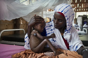 A woman holds her malnourished baby in the stabilisation ward at a hospital at Dadaab refugee camp. Since Al Shabaab, an Islamic militia with alleged links to Al Qaida, is controlling large parts of S...