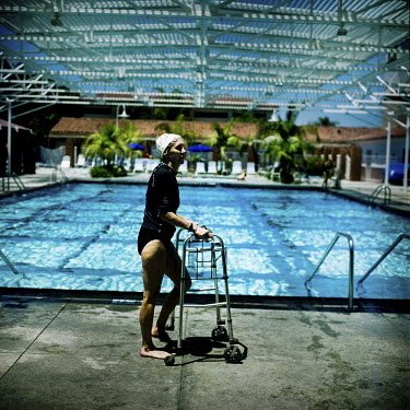 73 year old Margo Bouer uses a frame to help her walk before Aquadette practice at Laguna Woods, California. Margo suffers from severe MS, but says her nausea and shaking almost disappear when she is...