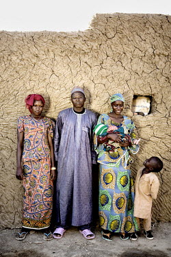 Hamidou poses with his new wife Ouma (14) and his first wife Sole with whom he has had four children, one of which died as an infant. In Niger, three out of every four women are married before the age...