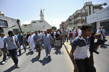 A funeral procession of a dead rebel fighter on a street in Tripoli. After a six month revolution, rebel forces finally managed to enter Tripoli and have taken control of Bab al-Aziziyah, Col Gaddafi'...
