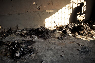Burned remains of corpses inside a warehouse. At least 50 people where found dead in a complex neighbouring the headquarters of the Khamis brigade in Tripoli. According to two survivors, the people wh...