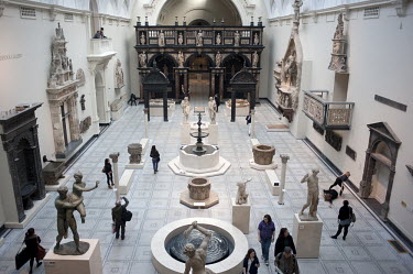 Sculptures at the Victoria and Albert Museum in London and people rehearse for a performance art piece to be held at the museum.