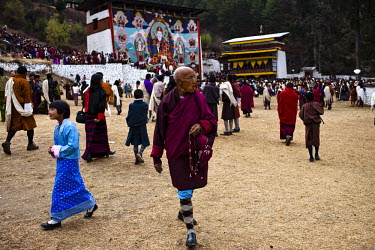 Local Bhutanese gather to witness an ancient and giant thangka, a silk painting with embroidery, being unveiled during a festival in Paro Dzong in Paro, Bhutan.