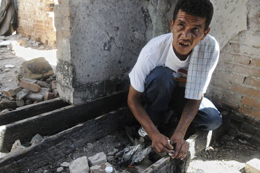A man nicknamed 'El Buitre - The Vulture' prepares a syringe with heroin in down town Juarez. Ciudad Juarez, has been plagued by drug violence. With over 3000 people killed in 2010, the city had offic...