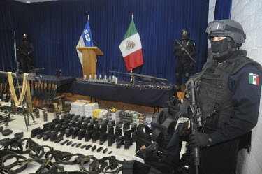 Ferderal police showing of a cach of confiscated weapons. Among them scores of AH 47's, but also a few 50 cal. large and 0.5 caliber machineguns. Ciudad Juarez, has been plagued by drug violence. With...