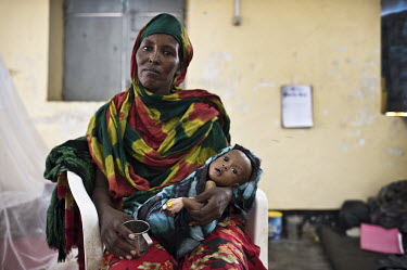 A mother sits with her child in the TFC (Therapeutic Feeding Centre) ward of Galcayo's hospital. Galcayo is a town in the self-declared autonomous state of Puntland. The populace in the region suffers...