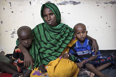 Habiba Dahir Muse sits with two of her children who are recovering from diphtheria in Galcayo's hospital. Two of her daughters died from the condition and following their funeral she travelled with he...