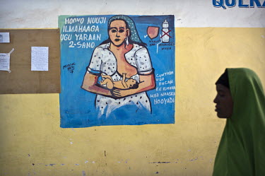 A hand painted public health message on the wall of a waiting room in Galcayo's hospital. It is promoting breast feeding which is less common than bottle feeding in Somalia. Galcayo is a town in the s...