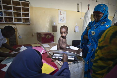 A nurse weighs one year old Daud who his mother, 22 year old Hibo Ismail Sugule, travelled with from Ethiopia's Ogaden region to seek medical treatment. The trip took two nights and two days and they...