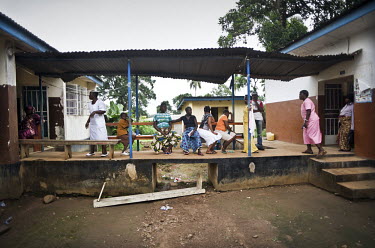 Pregnant women wait for treatment at a health centre in the village of Waterloo. A year ago Sierra Leone launched a free healthcare plan for pregnant women, breast-feeding mothers and children under f...