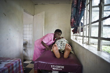 A pregnant women is examined by a midwife at a health centre in the village of Waterloo. A year ago Sierra Leone launched a free healthcare plan for pregnant women, breast-feeding mothers and children...