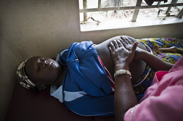 A pregnant women is axamiend by a midwife at a health centre in the village of Waterloo. A year ago Sierra Leone launched a free healthcare plan for pregnant women, breast-feeding mothers and children...