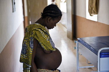 A pregnant women stands in a corridor in the maternity department at the regional hospital in Makeni. A year ago Sierra Leone launched a free healthcare plan for pregnant women, breast-feeding mothers...