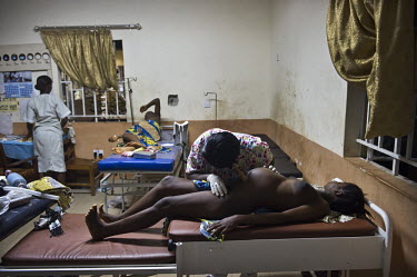 A nurse examines a pregnant women in labour at the regional hospital in Makeni. A year ago Sierra Leone launched a free healthcare plan for pregnant women, breast-feeding mothers and children under fi...
