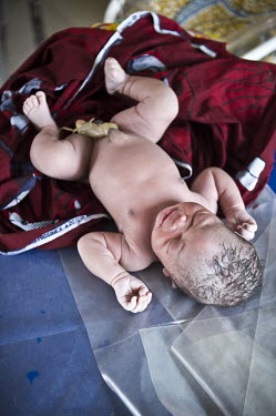A newborn baby at the regional hospital in Makeni. A year ago Sierra Leone launched a free healthcare plan for pregnant women, breast-feeding mothers and children under five years old, because for a l...