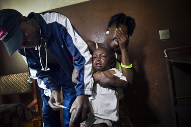 A child cries as he receives a vaccination at a health centre in the village of Waterloo. A year ago Sierra Leone launched a free healthcare plan for pregnant women, breast-feeding mothers and childre...