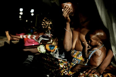 Twenty year old Rahika Gagere sits in tears with her son Ado at a Medecins Sans Frontieres (MSF) feeding centre. He is 11 months old but weighed just over four kilos when his mother bought him in. Aft...