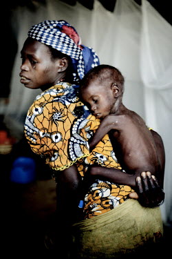 A mother carries her child on her back at a Medecins Sans Frontieres (MSF) centre for severely malnourished children.