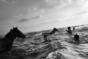 Horses and their owners take a dip in the Mediterranean Sea off Gaza City. The sea is a much needed distraction from the struggles of daily life in Gaza.