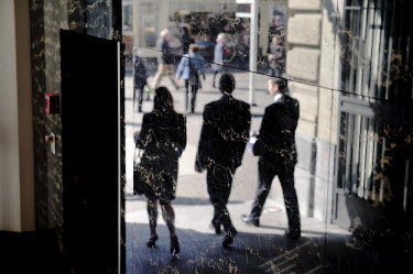 Businessmen and women reflected in the marble walls of the entrance to the Credit Suisse headquarters on Paradeplatz, the symbolic centre of the Swiss banking industry in central Zurich. The Swiss ban...