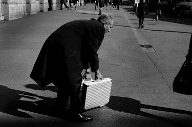 A man carries a pair of metal suitcases on Paradeplatz, the symbolic centre of the Swiss banking industry in the centre of Zurich. The Swiss banking industry holds an estimated 6,352 billion Swiss Fra...