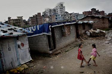 Two young girls play on a street in one of Kathmandu's slum neighbourhoods.