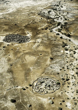 The parched landscape of Matheniko County seen from the air. The villages are circular structures made up of huts ringed by brushwood fences.