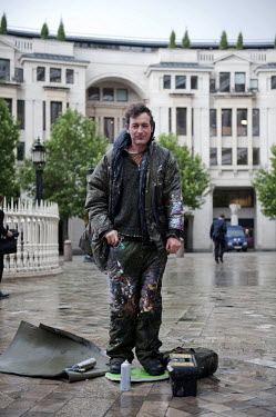 Artist Ben Wilson, dressed in his overalls, stands in a central London location while he takes a break from painting one of his unique minitures. He uses squashed chewing gum as his canvas and has bee...