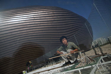 A worker in front of the unfinished museum in Ordos, Inner Mongolia. The Kangbashi District of Ordos, a district planned, five years ago, for 1 million inhabitants, still lies almost dormant and has b...