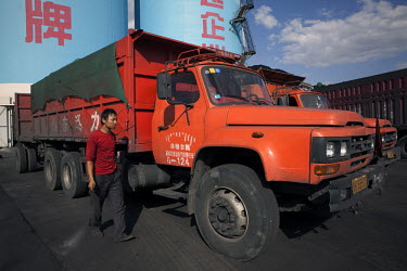 A coal truck driver secures his load after filling his vehicle with coal at the Yitai Coal Mine near Ordos The Kangbashi District of Ordos, a district planned, five years ago, for 1 million inhabitant...