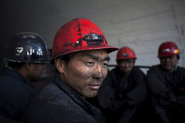 Coal miners are driven out of a mine shaft at the end of their shift at the Yitai Coal Mine near Ordos. The Kangbashi District of Ordos, a district planned, five years ago, for 1 million inhabitants,...