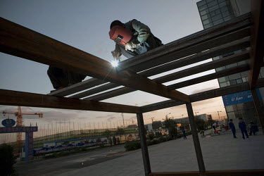 A worker welds steel giders on a construction site in Ordos. The Kangbashi District of Ordos, a district planned, five years ago, for 1 million inhabitants, still lies almost dormant and has become kn...