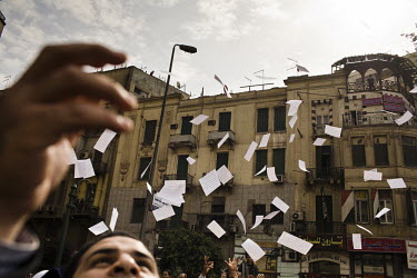 Leaflets, containing instructions for chants and slogans, float down into the hands of anti-government protestors demonstrating in Tahrir Square. 25 January 2011 saw the beginning of a nationwide 18 d...
