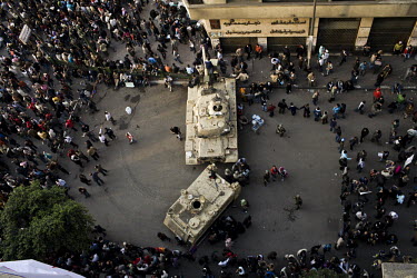 Protestors surround a tank and an armoured vehicle that have been stationed in Tahrir Square. 25 January 2011 saw the beginning of a nationwide 18 day protest movement that eventually ended the 30-yea...