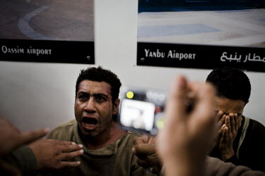 A suspected pro-Mubarak supporter, who have been beaten and detained by anti-government elements in a makeshift detention centre sited in an old travel agency in Tahrir Square, is photographed. 25 Jan...