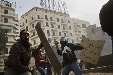 Anti-government protesters hurl rocks and stones at pro-Mubarak supporters just outside Tahrir Square. 25 January 2011 saw the beginning of a nationwide 18 day protest movement that eventually ended t...