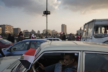 Anti-government protesters stream into Tahrir Square from the direction of the Qasser El Nil bridge. 25 January 2011 saw the beginning of a nationwide 18 day protest movement that eventually ended the...