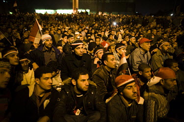 Anti-government protesters watch televised projections in Tahrir Square of a speech by President Hosni Mubarak. It is rumoured that the president is about to announce his resignation. 25 January 2011...