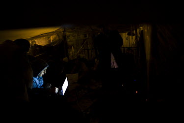 Behind a makeshift outdoor cinema screen young activists use their laptops and a 3g mobile internet connection to coordinate actions and gather more support for the anti-government protests taking pla...